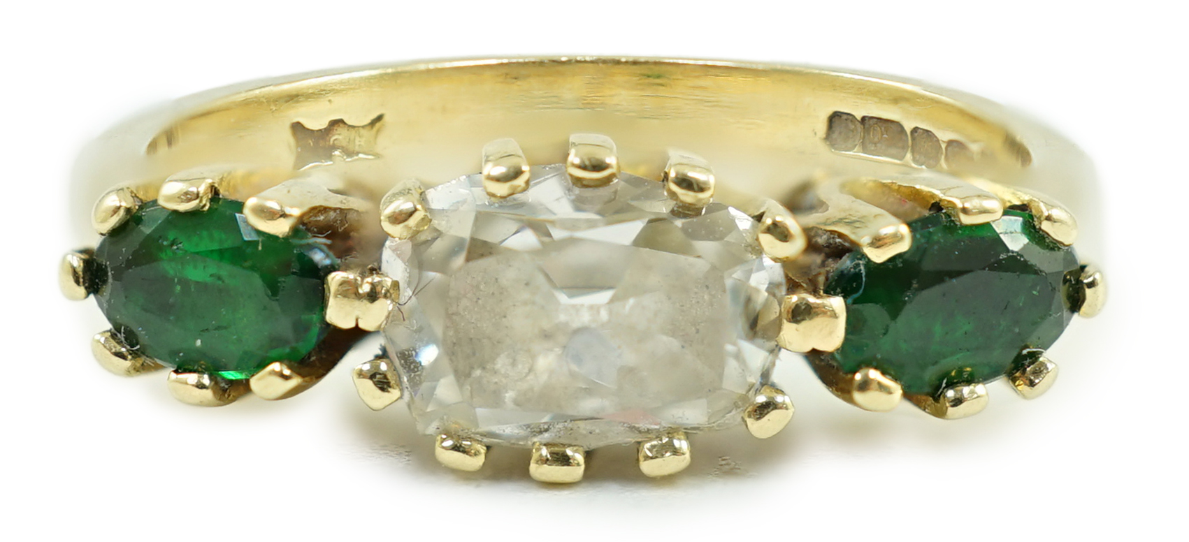 A modern 18ct gold, diamond and green tourmaline set three stone ring